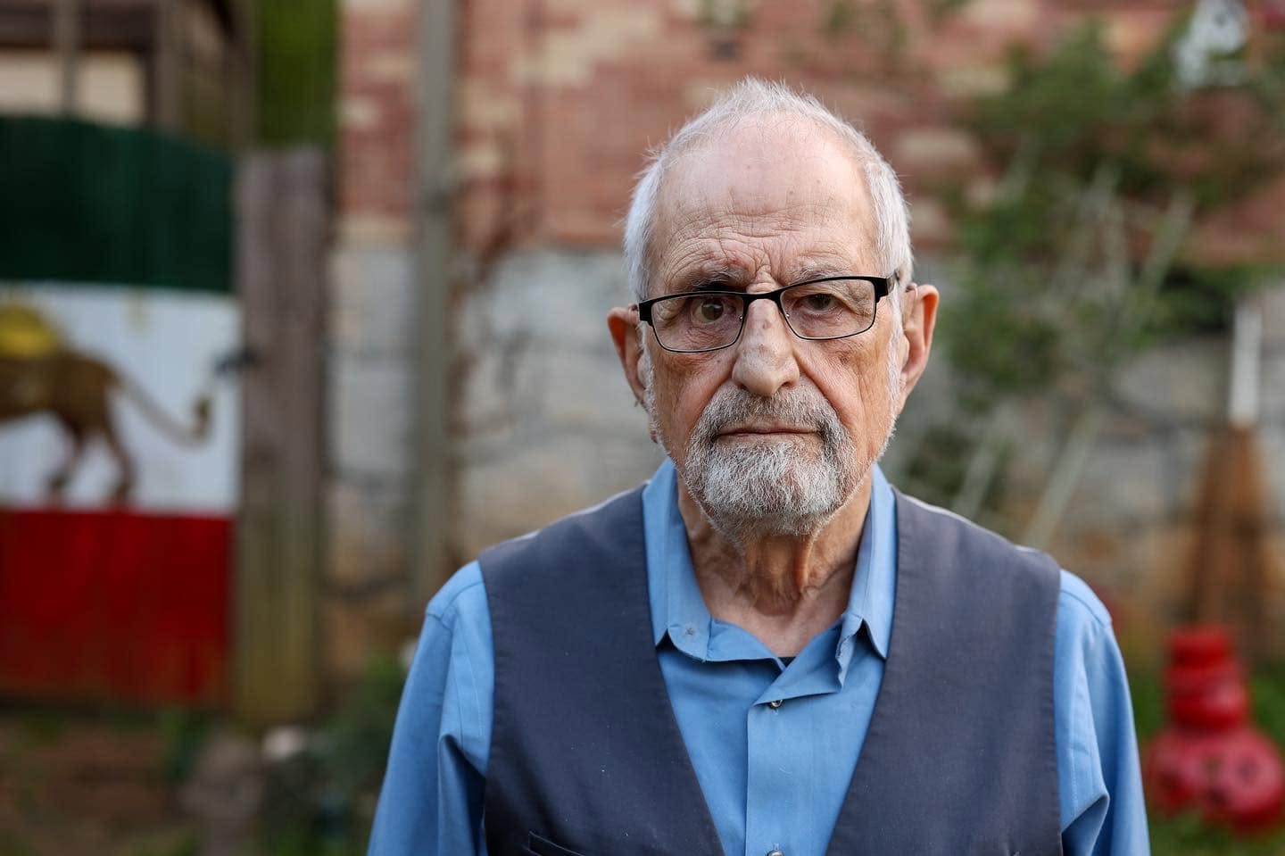 Elderly Man in a Blue Shirt and Vest